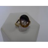 A 9ct gold ring set with an oval panel of Blue John,
