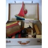 Vintage Noton suitcase containing an eclectic mix of items including a model yacht,