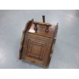 A Victorian oak mahogany coal box, having a turned wooden handle, panelled door,