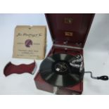 His Master's Voice red portable wind-up Gramophone, Calcutta retailer, with record tray,