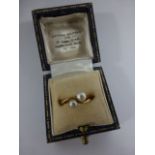 A 9ct gold (tested) twin pearl crossover ring, size H/I, together with a 9ct gold mounted Ivory