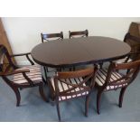 Mahogany oval dining table and six chairs (4+2 carvers), the table on twin supports,