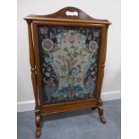 A walnut fire screen with carved handle, turned side supports and splayed feet,