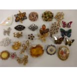 Collection of twenty four vintage brooches and a scarf clip