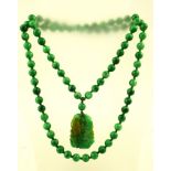 A CARVED JADE PENDANT NECKLACE, with two carved fish, 100cm long, without clasp, 139g