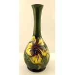 WILLIAM MOORCROFT A BULB SHAPED EARTHENWARE VASE, decorated with a yellow hibiscus on green