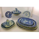 A QUANTITY OF BLUE AND WHITE TRANSFER DECORATED POTTERY to include; meat dishes and two tureens