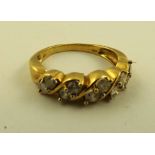 A 1980's/90's DIAMOND HALF HOOP RING having five pairs of brilliants diagonally set in a gold