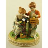 A MID 20TH CENTURY DRESDEN PORCELAIN FIGURE GROUP depicting a boy and a girl with garland of flowers