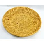 A MID 20TH CENTURY WOVEN GRASS COILED SHALLOW BASKET probably for separating chaff, 54cm diameter