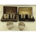 A CASED PAIR OF PIERCED SILVER NAPKIN RINGS, Sheffield 1908, together with ANOTHER PAIR OF CASED