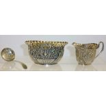 ATKIN BROTHERS A PRESSED DECORATED SILVER CREAM JUG, SUGAR and a silver SIFTING SPOON, Old English