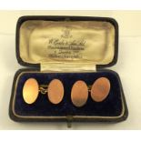 A PAIR OF 9CT ROSE GOLD PLAIN OVAL CUFFLINKS in presentation case