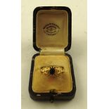 AN EDWARDIAN STYLE GOLD COLOURED METAL MOUNTED SAPPHIRE AND DIAMOND RING having central sapphire