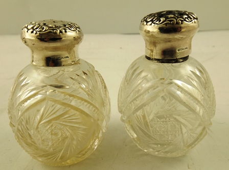 A PAIR OF SILVER COLOURED METAL CONDIMENTS, each having a foliate decorated screw-fit lid upon an - Image 2 of 3