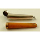 STOKES & IRELAND LTD. A SILVER SLEEVED AMBER CIGARETTE HOLDER, having 9ct gold banded top in a