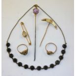 A SELECTION OF ITEMS to include an amethyst HAT PIN, a gold coloured metal TIE PIN set claw, two