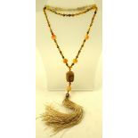 A JADE CARVED SAUTOIR BUDDHA HEAD with tassel, on bead chain, 80cm long