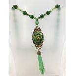 A MAX NEIGER SAUTOIR EGYPTIAN REVIVAL DESIGN NECKLACE having green beads with Pharaoh head