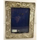 WILLIAM NEALE LTD AN EDWARDIAN ART NOUVEAU SILVER MOUNTED EASEL FORM PHOTOGRAPH FRAME embossed