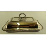 A SILVER PLATED CUSHION FORM ENTREE DISH WITH COVER having removable handle, gadroon edge