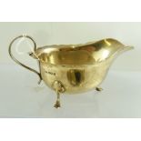 MAPPIN & WEBB AN EDWARDIAN CHIPPENDALE STYLE SILVER SAUCE BOAT having cut shaped rim, raised on