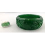 A CARVED SPINACH JADE BANGLE (inner dimension 6cm) and a SILVER JADE SET RING