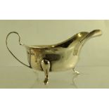 EDWARD VINER A CHIPPENDALE STYLE SILVER SAUCE BOAT having cut shaped rim, plain belly and three hoof