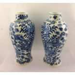 A PAIR OF CHINESE BALUSTER VASES, cobalt blue decoration with dragons amidst blooms, painted