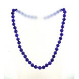 A UNIFORM ROW RUSSIAN AMETHYST SPHERICAL BEAD NECKLACE, weighing 65g, with gold coloured metal clasp