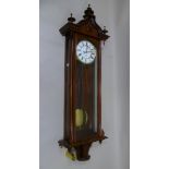 A 19TH CENTURY WALNUT CASED VIENNA WALL CLOCK the case with turned finials, white enamel dial with