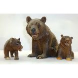 A FAMILY OF EARLY 20TH CENTURY GERMAN CARVED BEARS, mother seated and two cubs standing, 13cm high