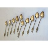 A SET OF TEN WHITE METAL COFFEE SPOONS probably South American with Llama terminals on decorative