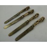 FOUR GEORGIAN/VICTORIAN SILVER HANDLED KNIVES each cast with one of the King/Queens Beasts and