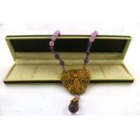 AN EGYPTIAN REVIVALIST PURPLE AND LILAC NECKLACE with mummy and beetle, 42cm long