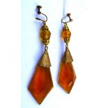 A PAIR OF ART DECO LONG AMBER GLASS EARRINGS with gilt metal screw fittings