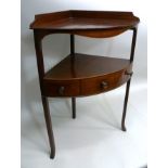 A 19TH CENTURY MAHOGANY CORNER WASHSTAND with galleried back, under tier fitted drawer, raised on