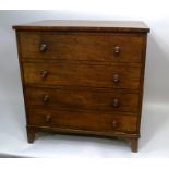 A 19TH CENTURY MAHOGANY COMMODE CHEST having hinged cover over four faux drawers with brass knob