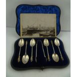 A VICTORIAN PRESENTATION SET OF SIX APOSTLE TEA SPOONS AND A PAIR OF SUGAR NIPS, in silk and