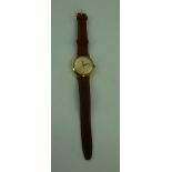 AN ACCURIST 9CT GOLD CASED GENTLEMAN'S WRIST WATCH, 21 jewel, with leather strap