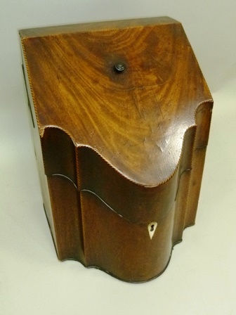 A GEORGE III MAHOGANY KNIFE BOX having sloping hinged lid over serpentine front, remains of original