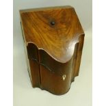A GEORGE III MAHOGANY KNIFE BOX having sloping hinged lid over serpentine front, remains of original