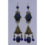 A PAIR OF SUBSTANTIAL EGYPTIAN REVIVAL EARRINGS with blue glass ovals and silver coloured metal