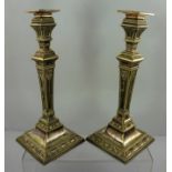 A PAIR OF LATE VICTORIAN SILVER PLATED CANDLESTICKS of tapering column designs with graduated bell