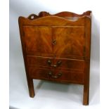 A GEORGE III MAHOGANY TRAY TOP COMMODE with pierced side handles over two door cupboard and