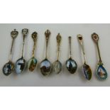 A COLLECTION OF EIGHT EARLY 20TH CENTURY WHITE METAL AND ENAMEL COMMEMORATIVE SPOONS, includes;