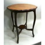 AN EDWARDIAN MAHOGANY OCCASIONAL TABLE having pie-crust rim, on four shaped supports united by