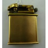 AN EARLY 20TH CENTURY GOLD COLOURED METAL CIGARETTE LIGHTER, having detachable gold sleeve engine