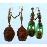 A PAIR OF PEKING GLASS DROP EARRINGS and a PAIR OF CINNABAR EARRINGS carved with Buddha motifs,