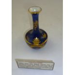 AN EARLY 20TH CENTURY CARLTON WARE VASE "New Mikado" patterned, gilded on a blue ground, 12cm high